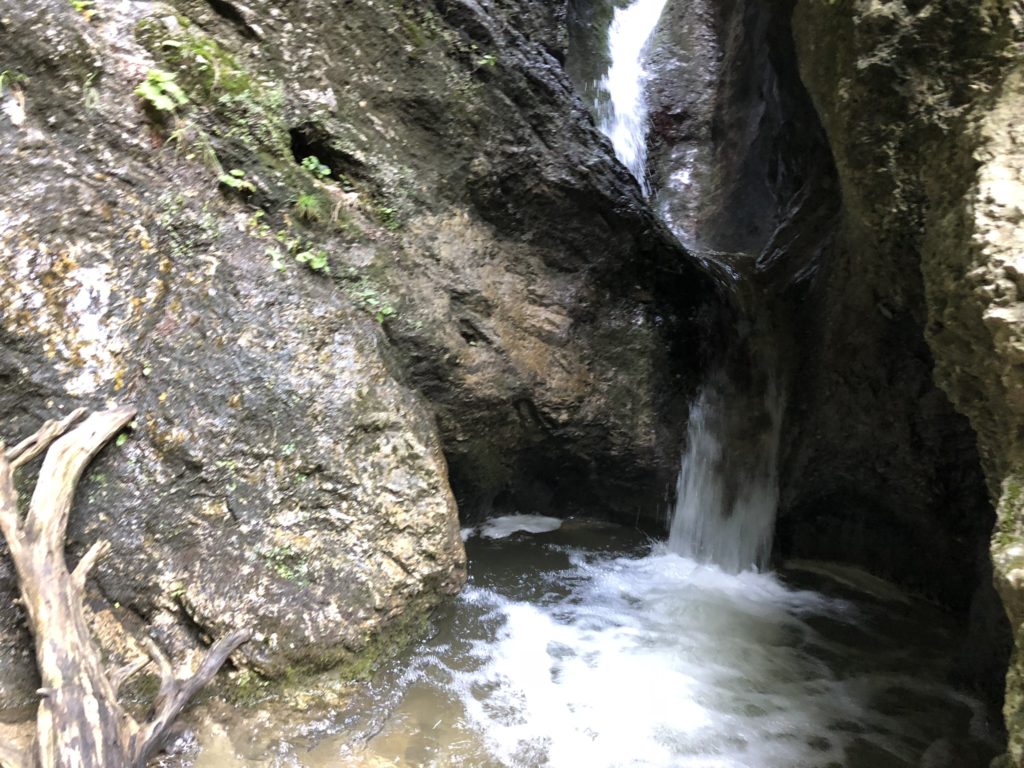 Small waterfall cascading between mossy rock walls in Jánošík’s Lower Holes