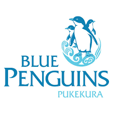 Blue Penguins Pukekura logo featuring three blue penguins on a wave graphic