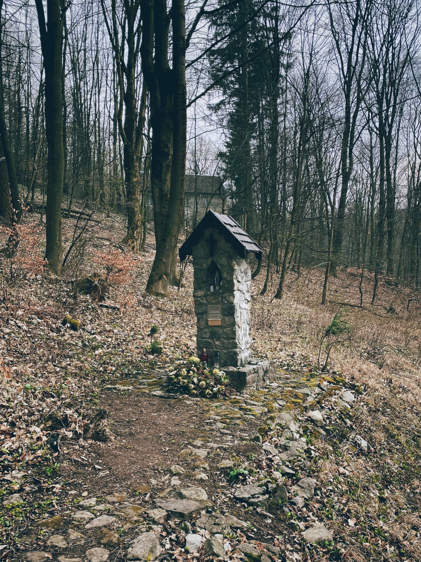 Small stone shrine standing on a forest trail in Plavecký Mikuláš