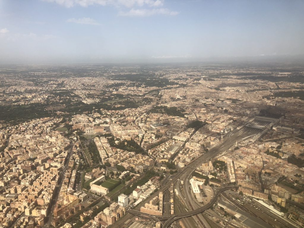 Aerial view of the sprawling city of Rome with dense buildings and roads