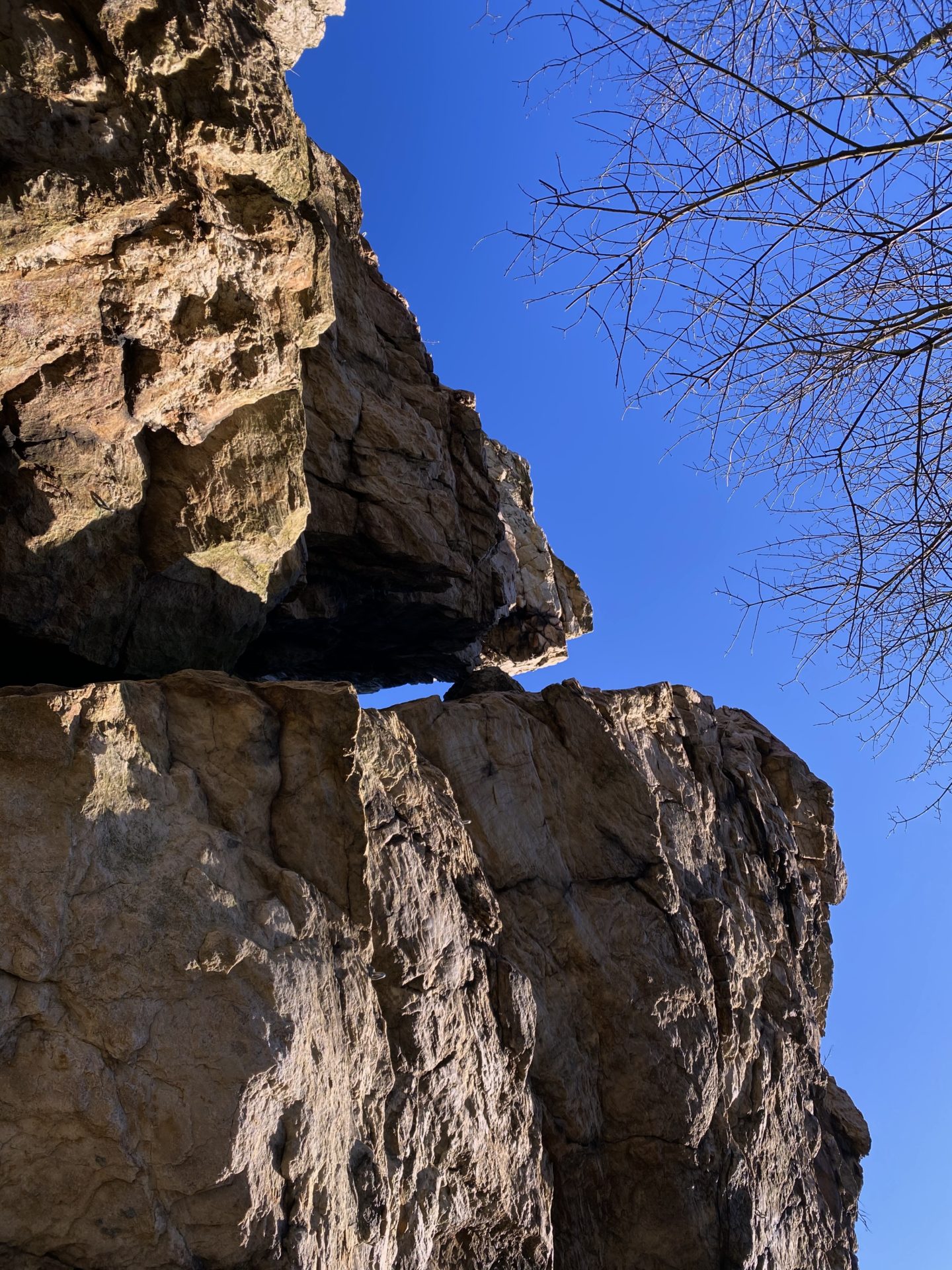 Jagged rock formations rise against a clear blue sky in the Little Carpathians