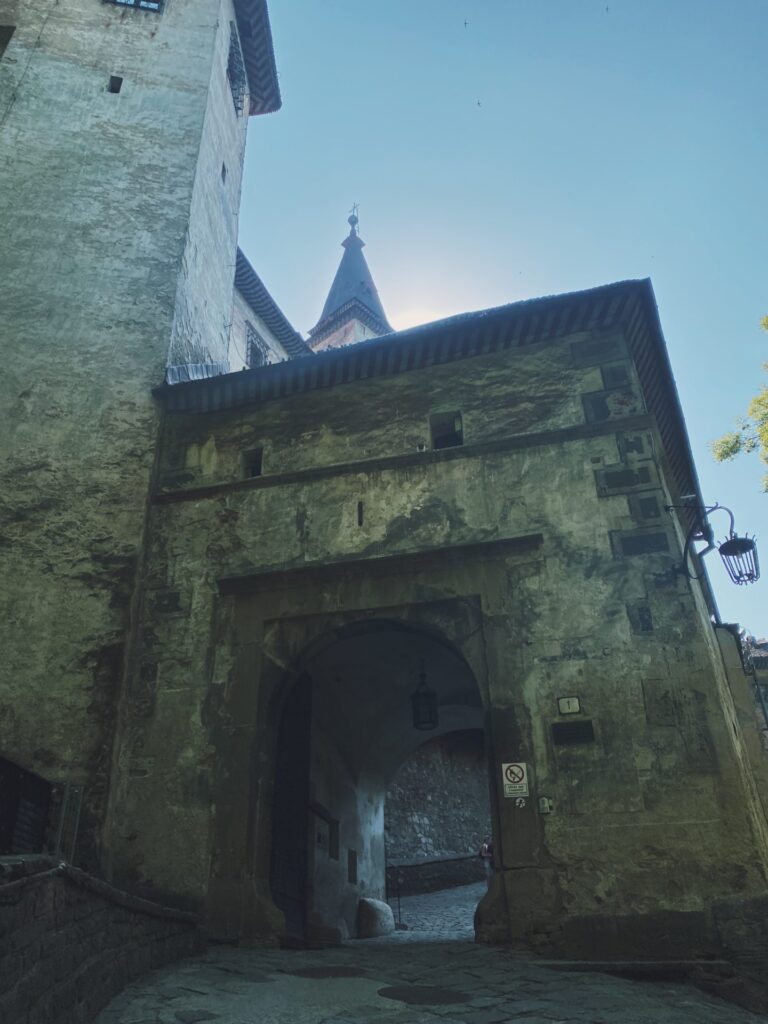 An arched stone gateway leading into the courtyard of Orava Castle