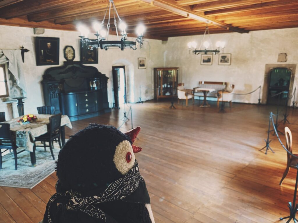 A plush toy overlooks a furnished room inside Orava Castle