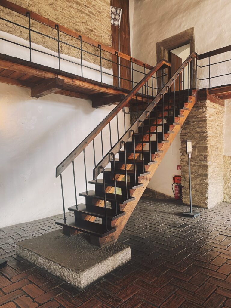 Wooden staircase with metal railings inside Orava Castle