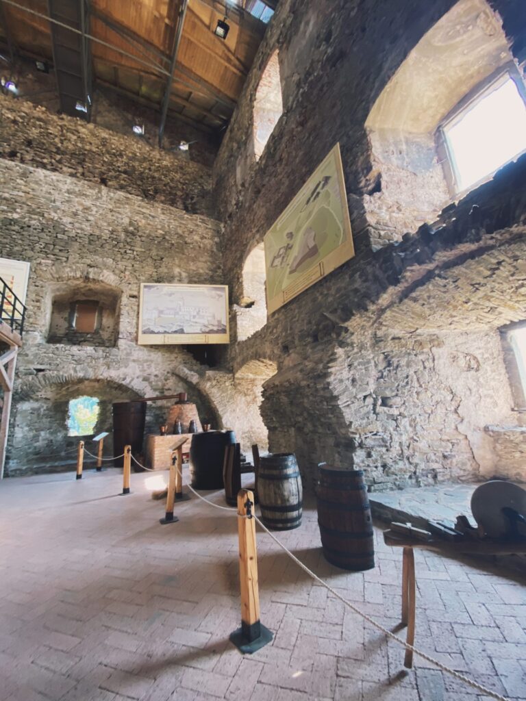 Wooden barrels stand inside the stone walls of Stará Ľubovňa Castle