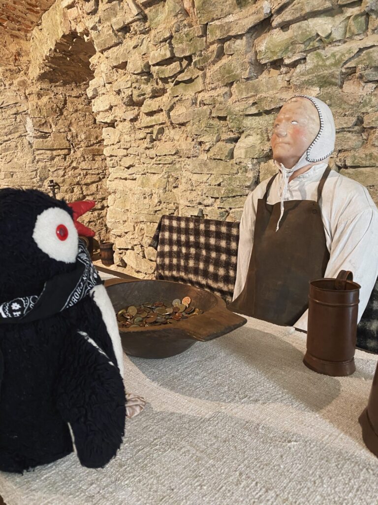 A stuffed penguin faces a mannequin at Stará Ľubovňa Castle