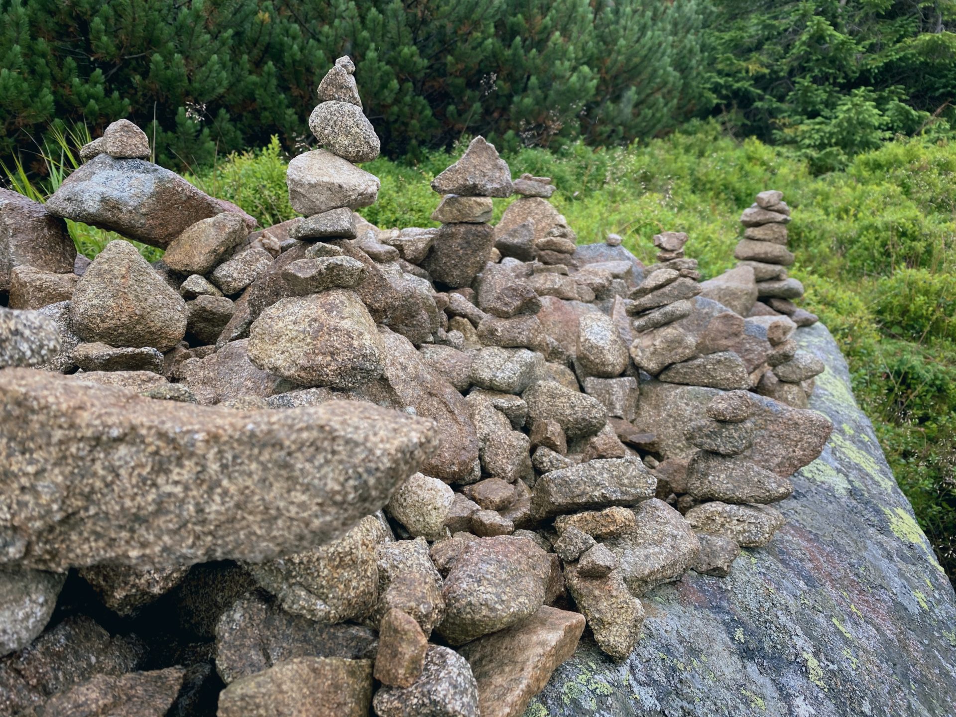 Small stone cairns stacked on a large rock in the Low Tatras