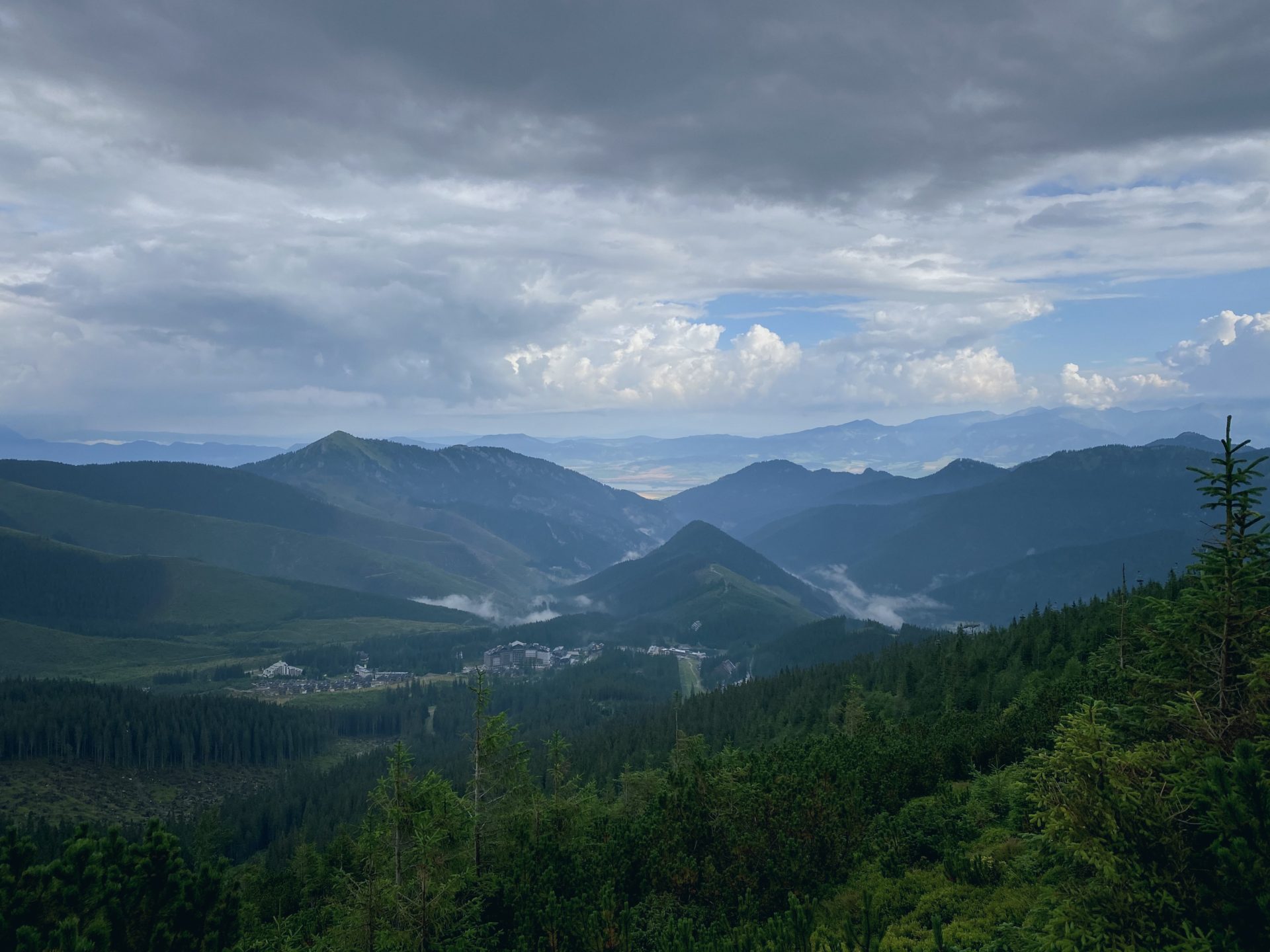 Mountain peaks and a valley village under a cloudy sky in Low Tatras