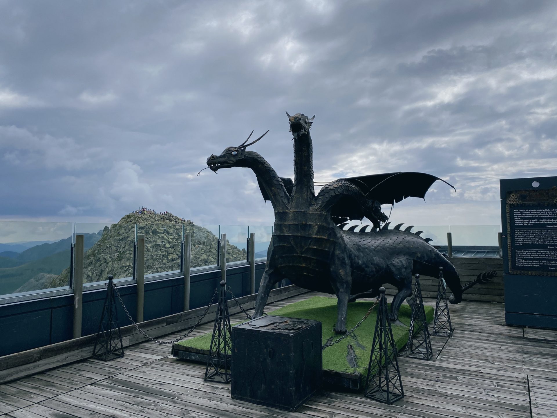 Three-headed metal dragon statue overlooking the Low Tatras mountains