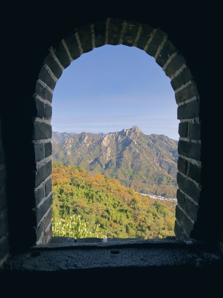 View of mountains through a stone archway on the Great Wall of China