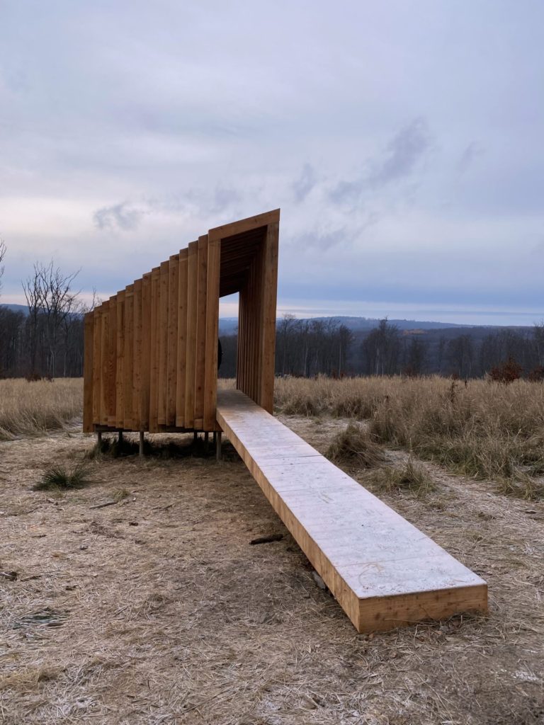 Wooden structure at the Vydrica Observatory overlooking a field and forest