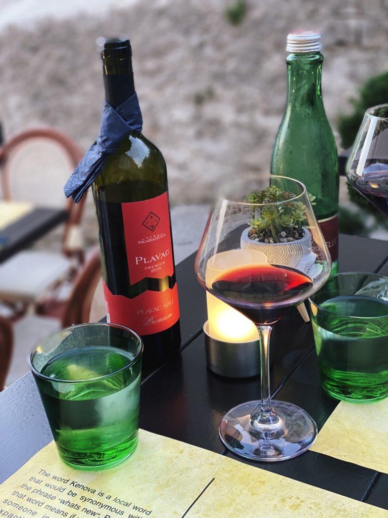Red wine and green water glasses on a table in Dubrovnik