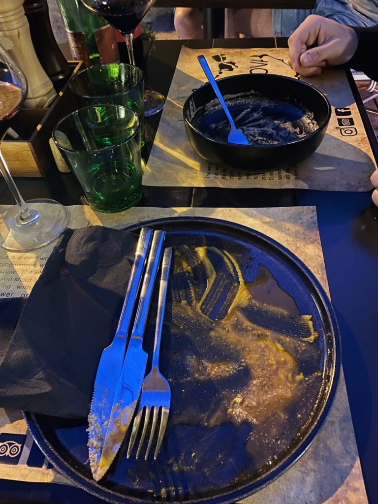 Plates with food remnants and sauce sit on a table in Dubrovnik