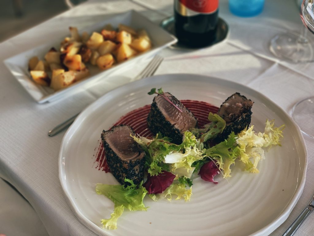 Sesame crusted tuna with salad and a side of roasted potatoes in Alghero