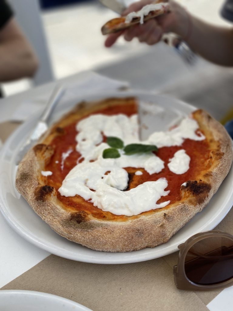 A pizza topped with fresh mozzarella and basil in Alghero, Sardinia