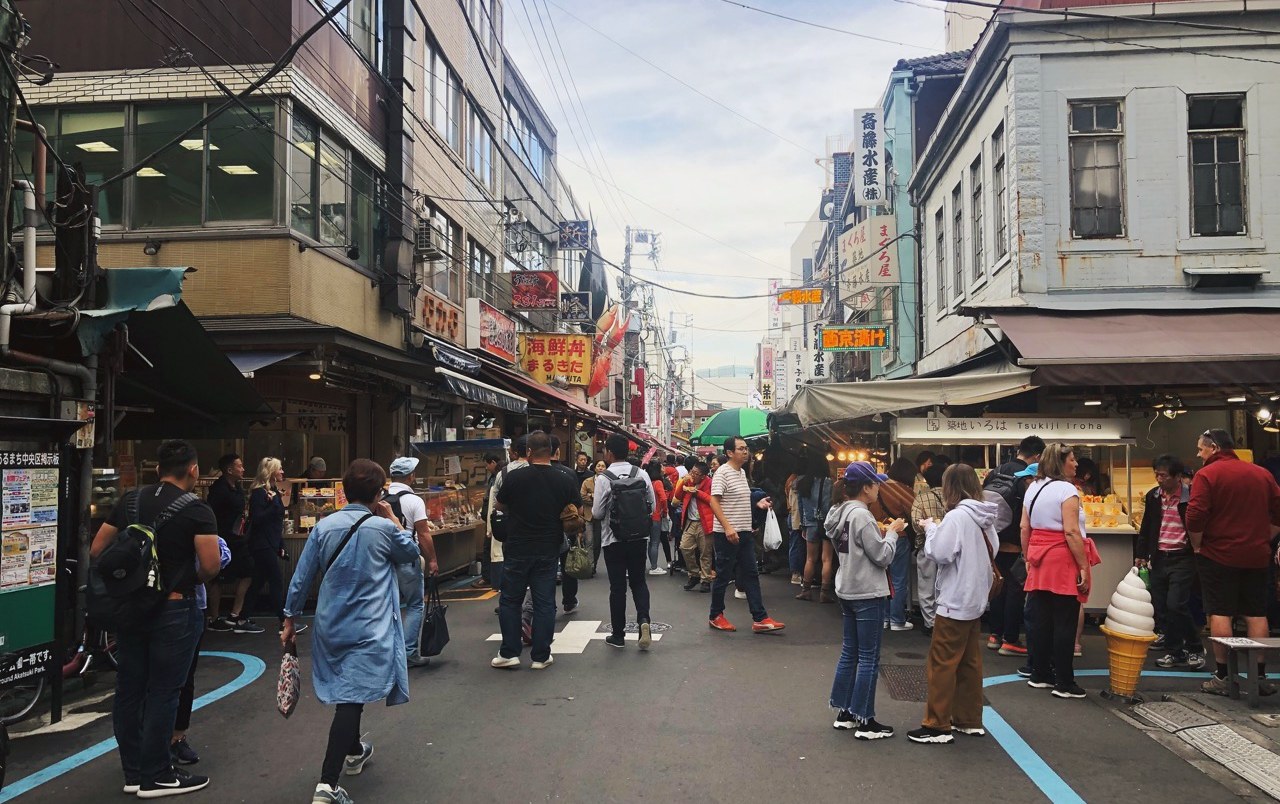 A busy street of food stalls at a market in Tokyo