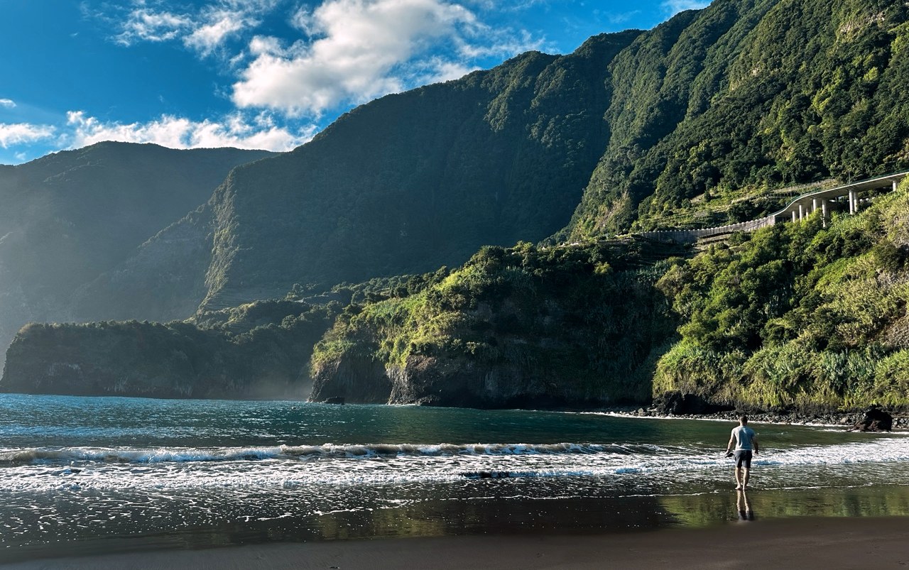 Green cliffs above the black sand beach at Seixal, Madeira