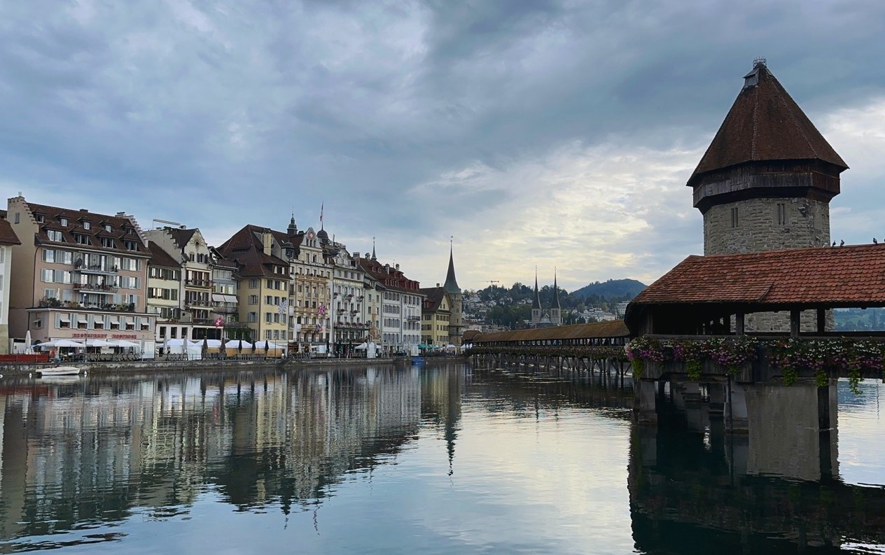 The Chapel Bridge tower and old town houses reflected in the Reuss, Lucerne