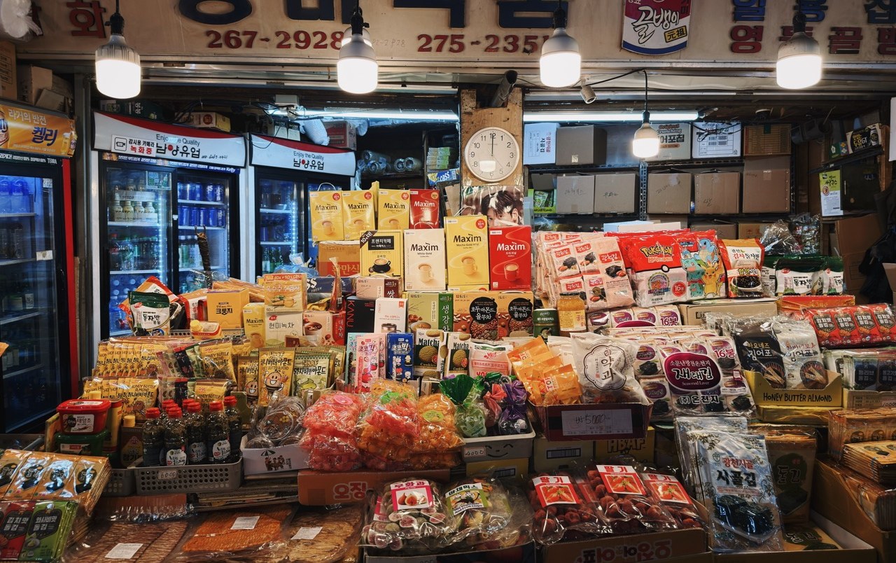 A stall at Gwangjang Market in Seoul piled high with packaged snacks and goods