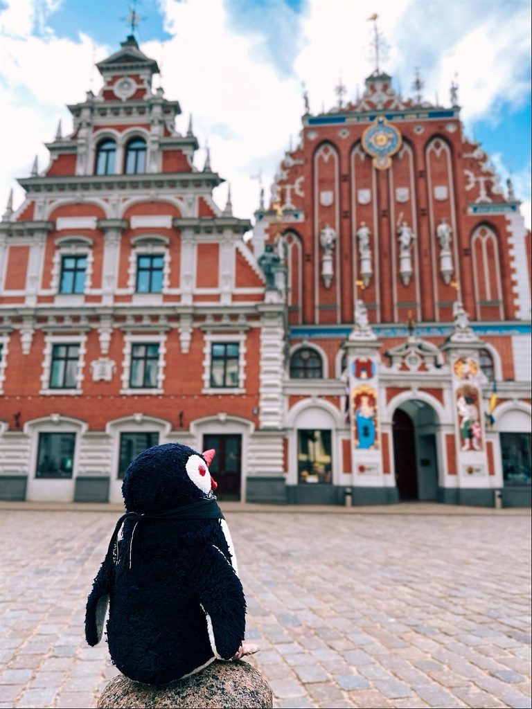 Winter scene on a Riga street, historic facades line the cobblestones as pedestrians stroll leisurely