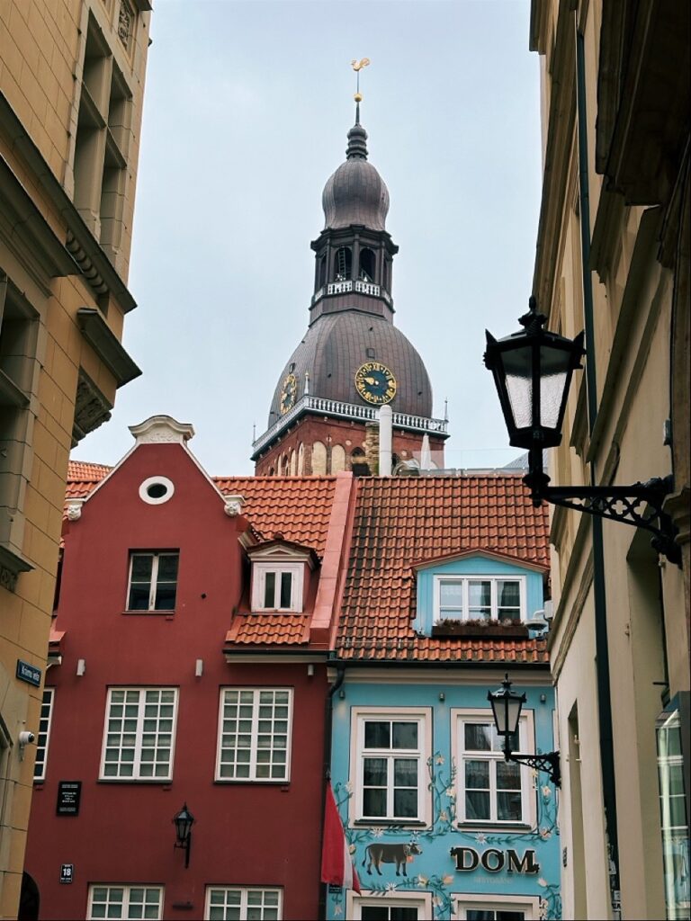 Riga city building with tall steeple and a sign