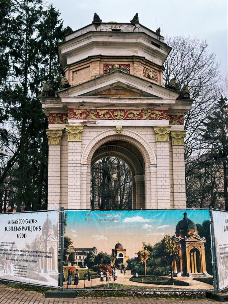 Historic arch pavilion with a 1901 Latvian commemorative plaque reading RIGAS 700 GADES JUBILEJAS PAVILJONS