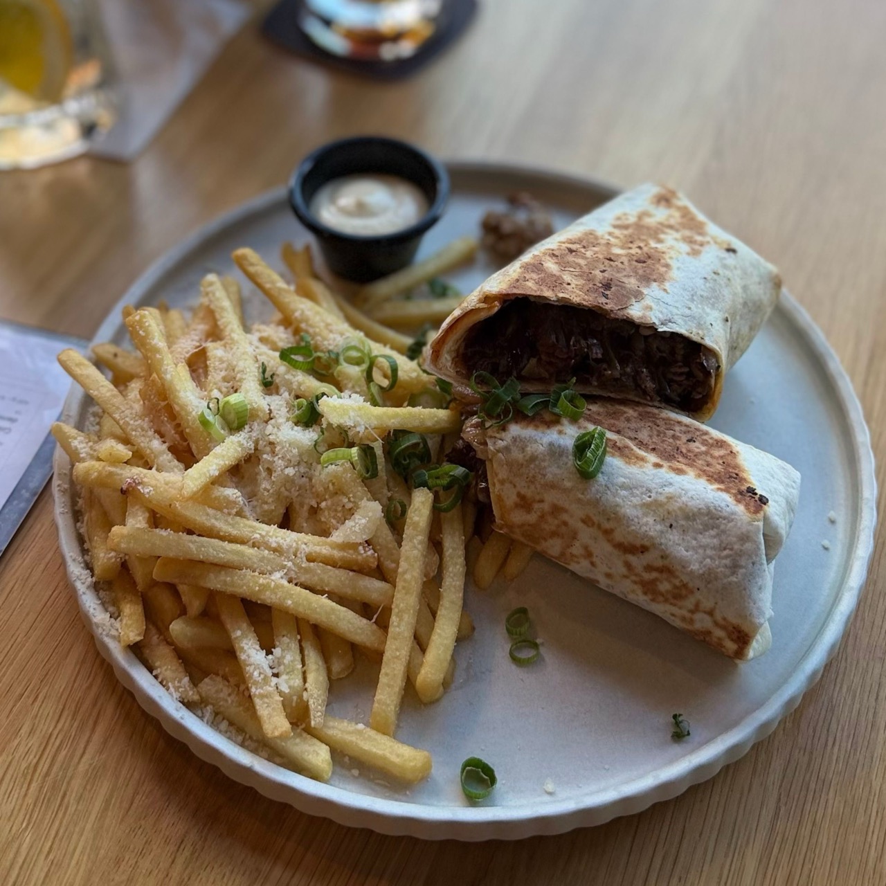 Plate of golden fries on a white plate beside a small sign, served at Brejk Bistro Prešov