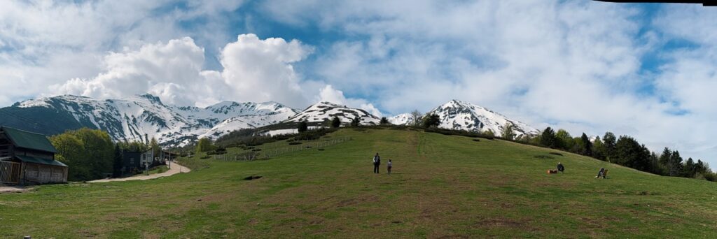 Panoramic view of green hills and snow-capped mountains on the way from Skopje to Prizren