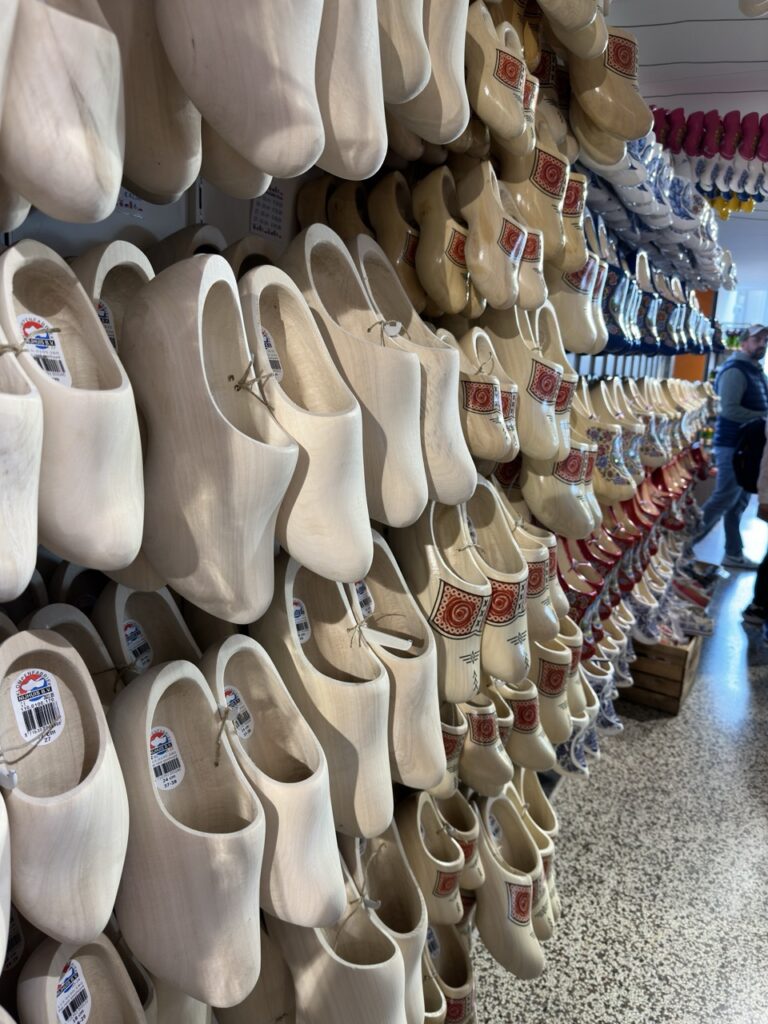 Rows of wooden clogs displayed on a wall in the Netherlands