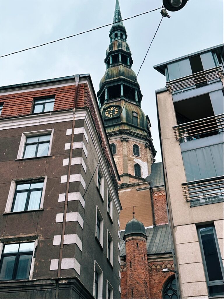 Historic building with tall steeple and ornate facade in Riga's city center