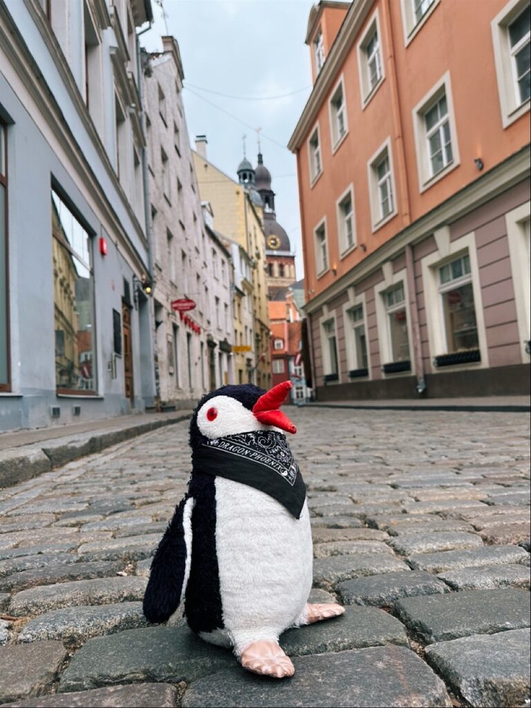 A woolen stuffed penguin with a beak, its fluffy body visible