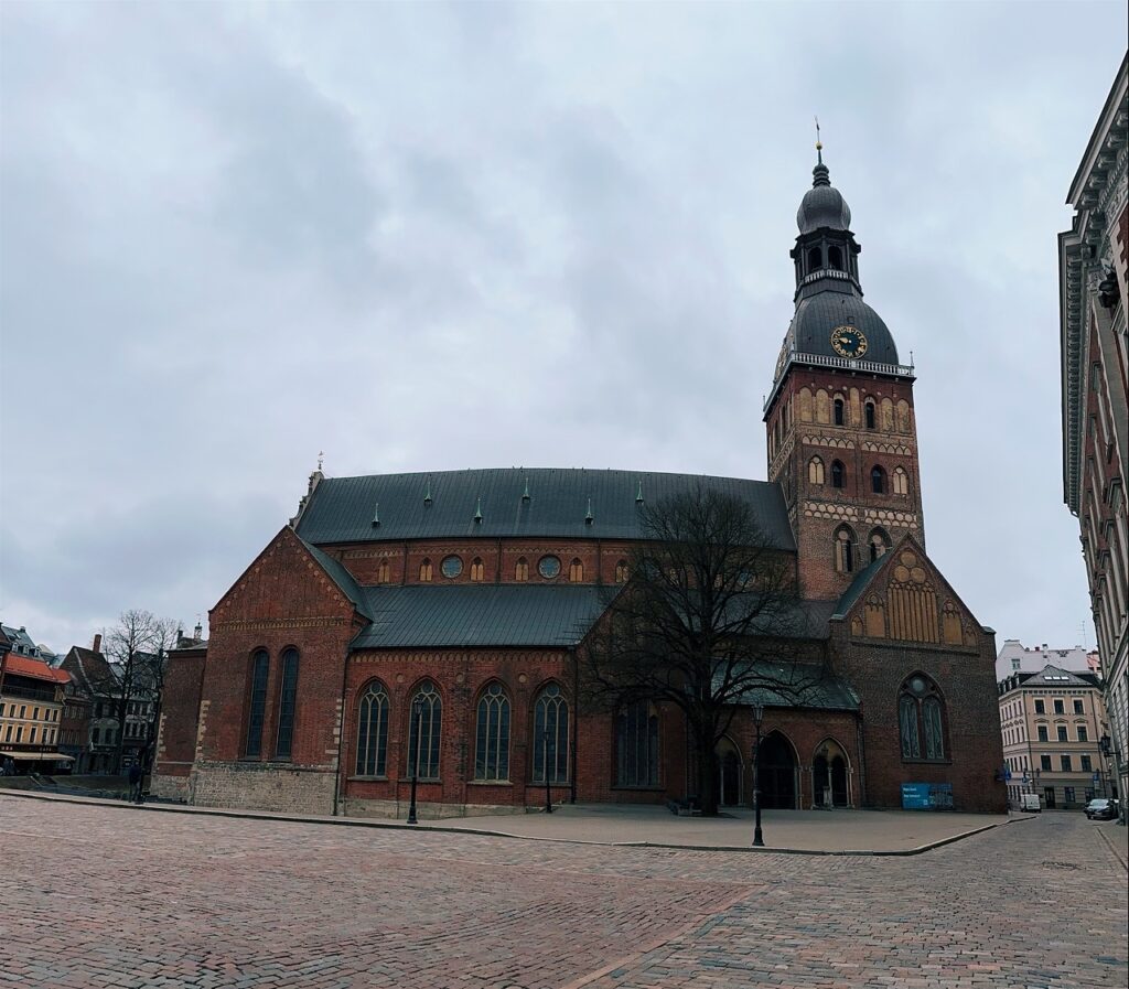 Key To Riga church with tall spire and medieval façade