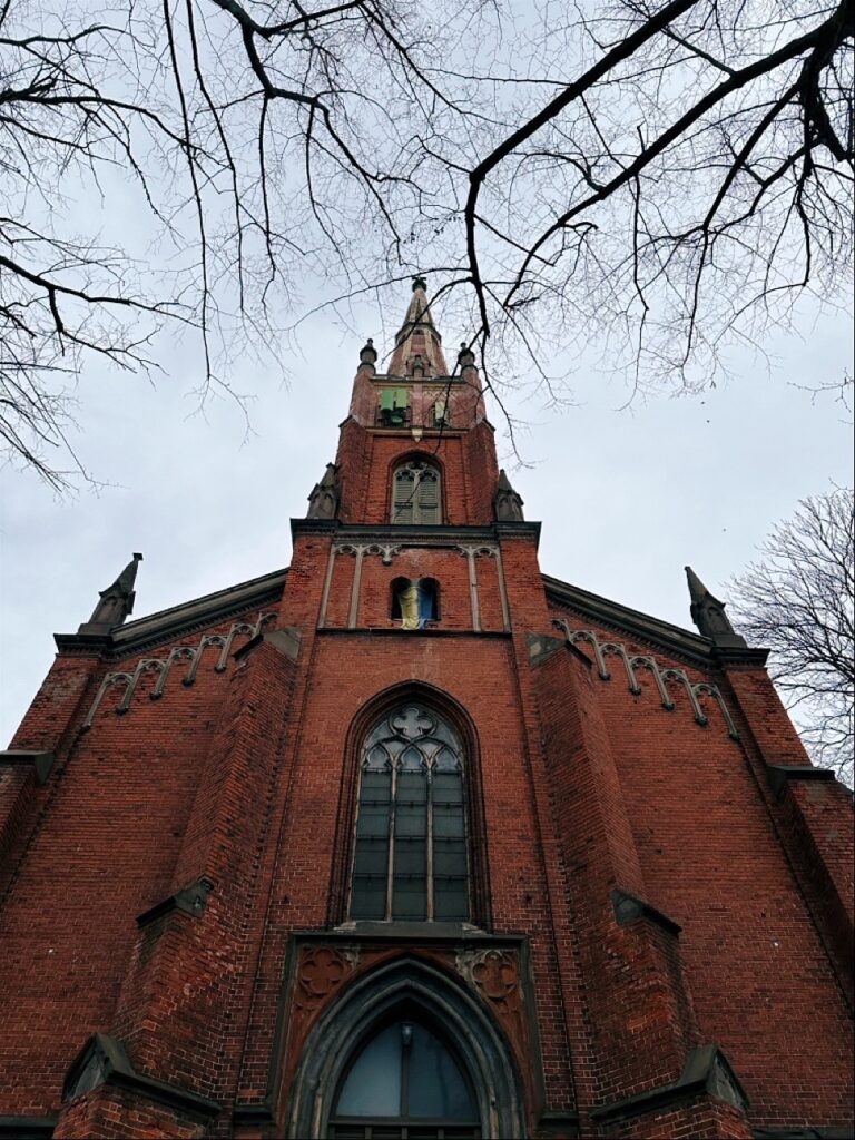 Tall medieval church spire with steep roof in Riga