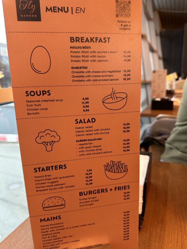Orange restaurant menu board with a sign displayed