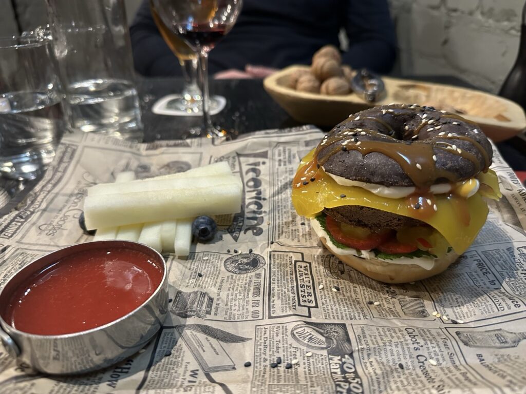 A plate of assorted finger foods on a table beside a small sign
