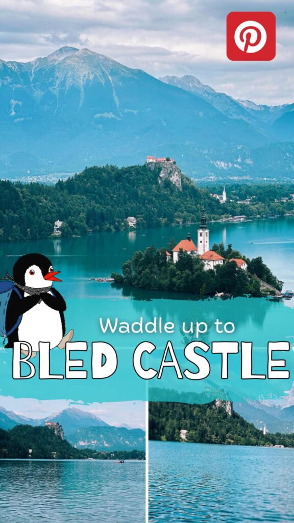 Cartoon penguin stands before a lake with Bled Castle and mountains behind