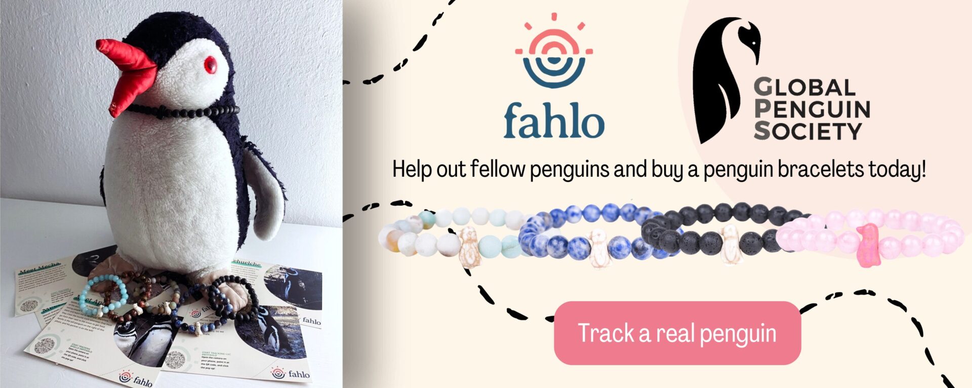 Plush penguin Miško next to a promotional banner for Fahlo penguin tracking bracelets
