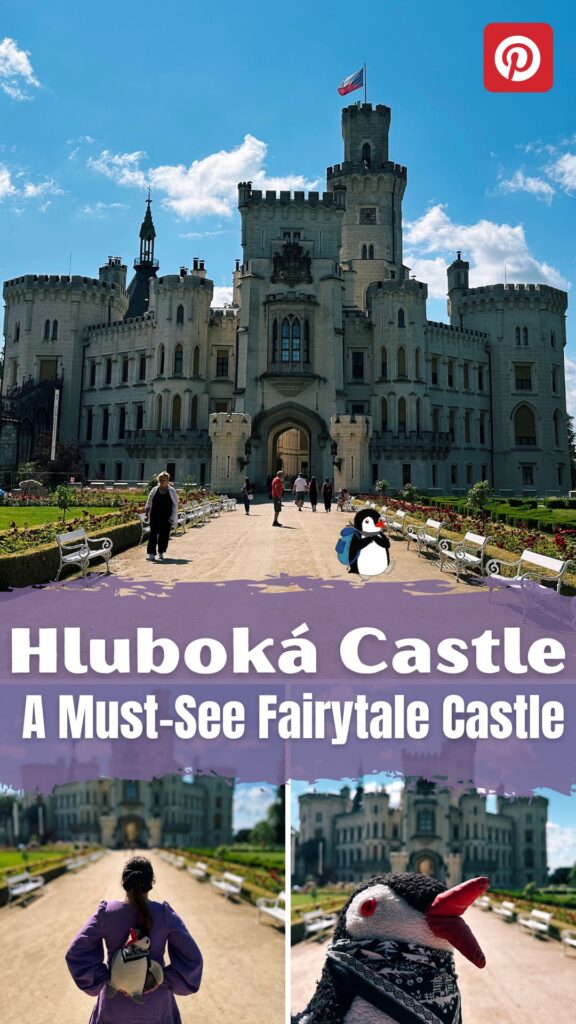 Visitors walk along a path toward the grand stone Hluboká Castle