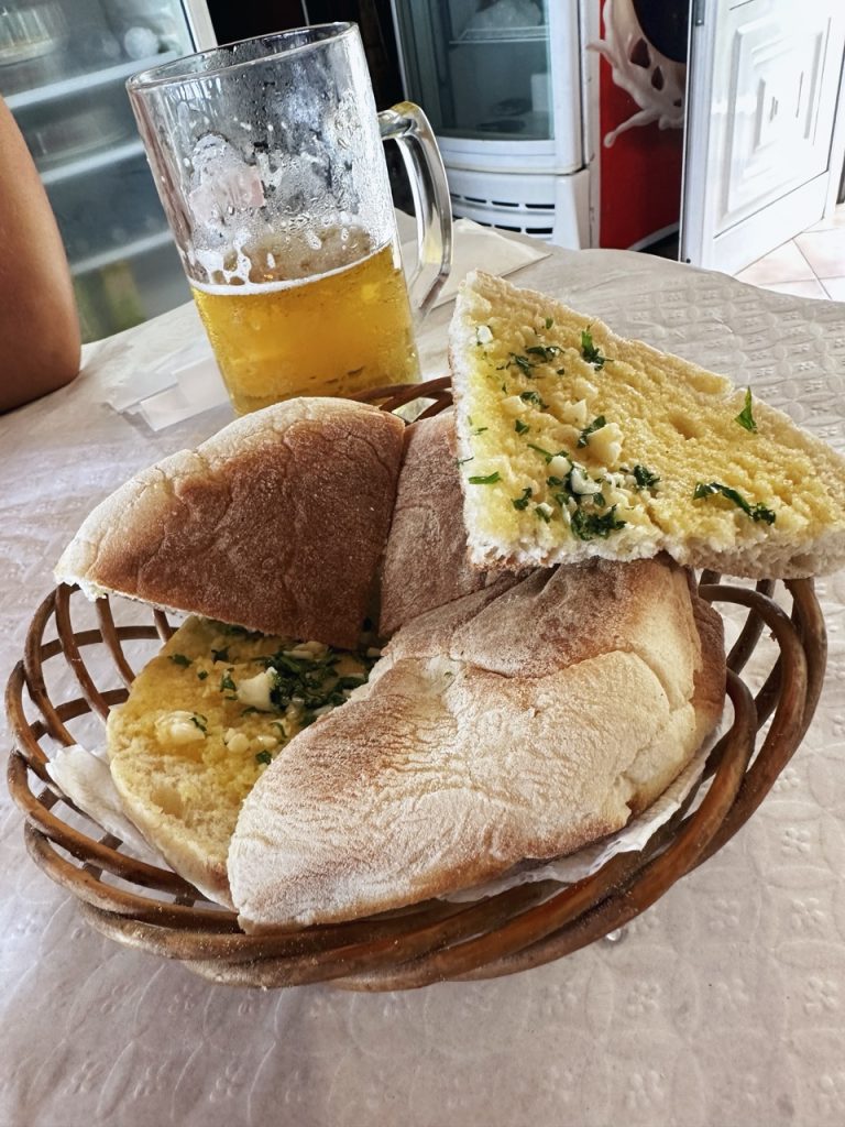 Basket of garlic bread in Madeira served with a glass of beer