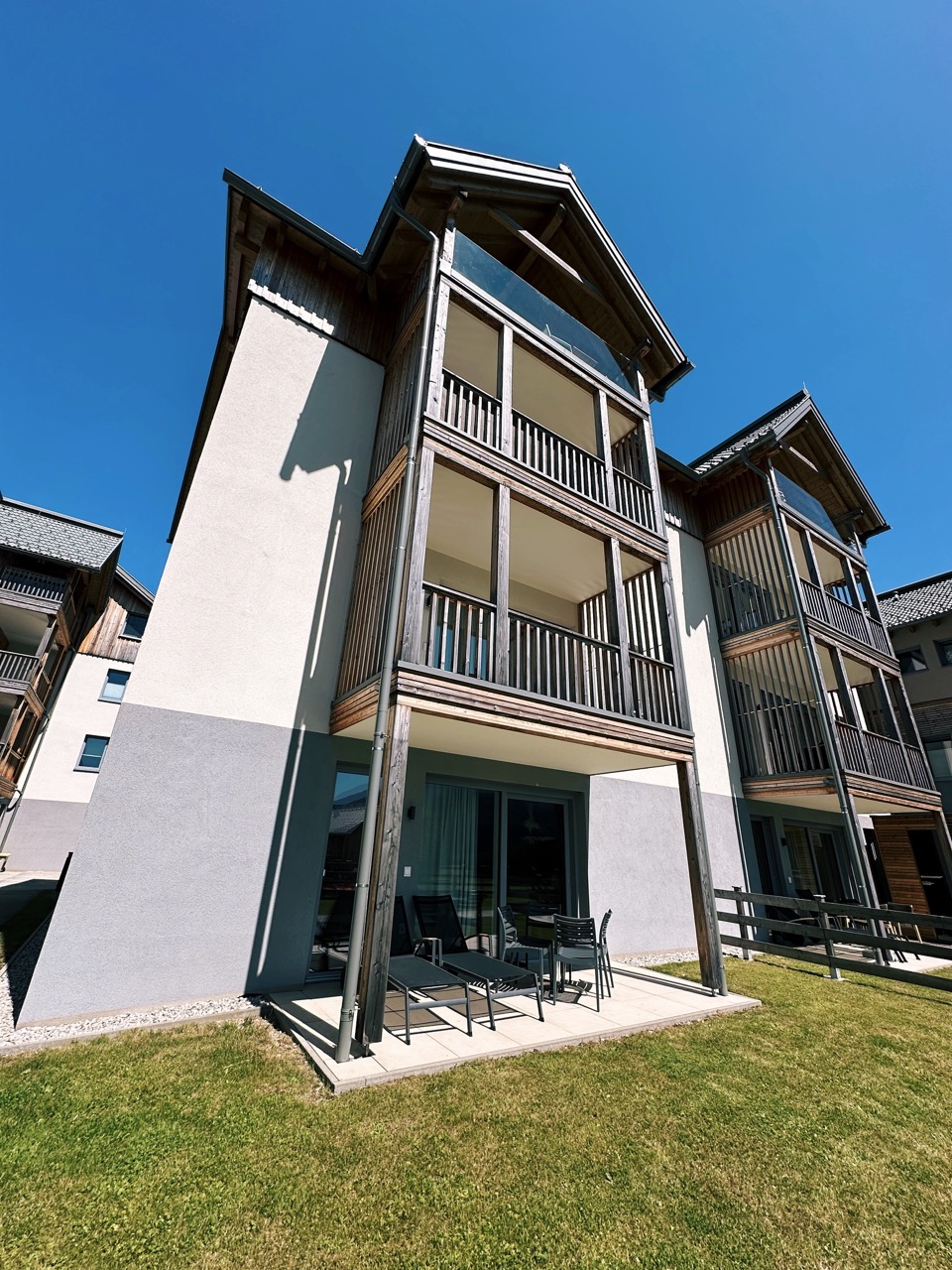 Modern multi-story lodge in Tauplitz with wooden balconies and a patio area