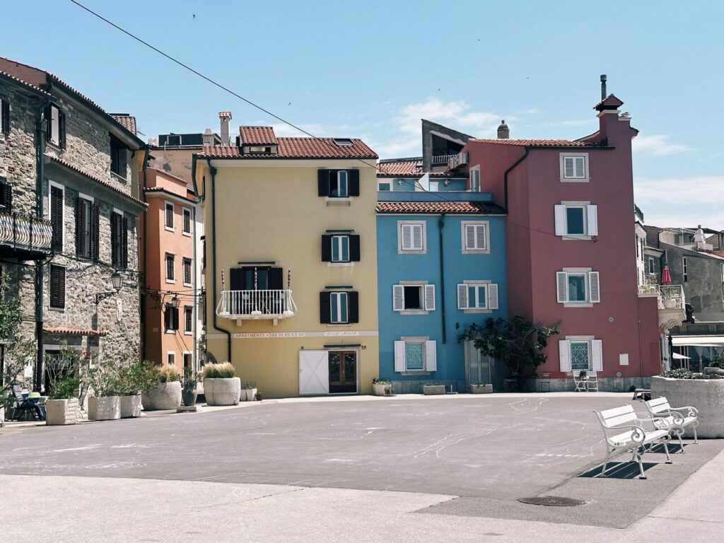 Colorful buildings line a quiet square in the coastal town of Piran