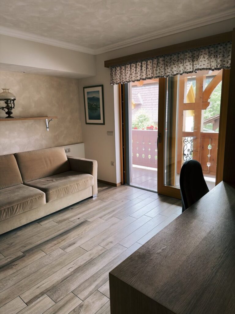 Cozy room with a sofa and balcony view in Slovenia