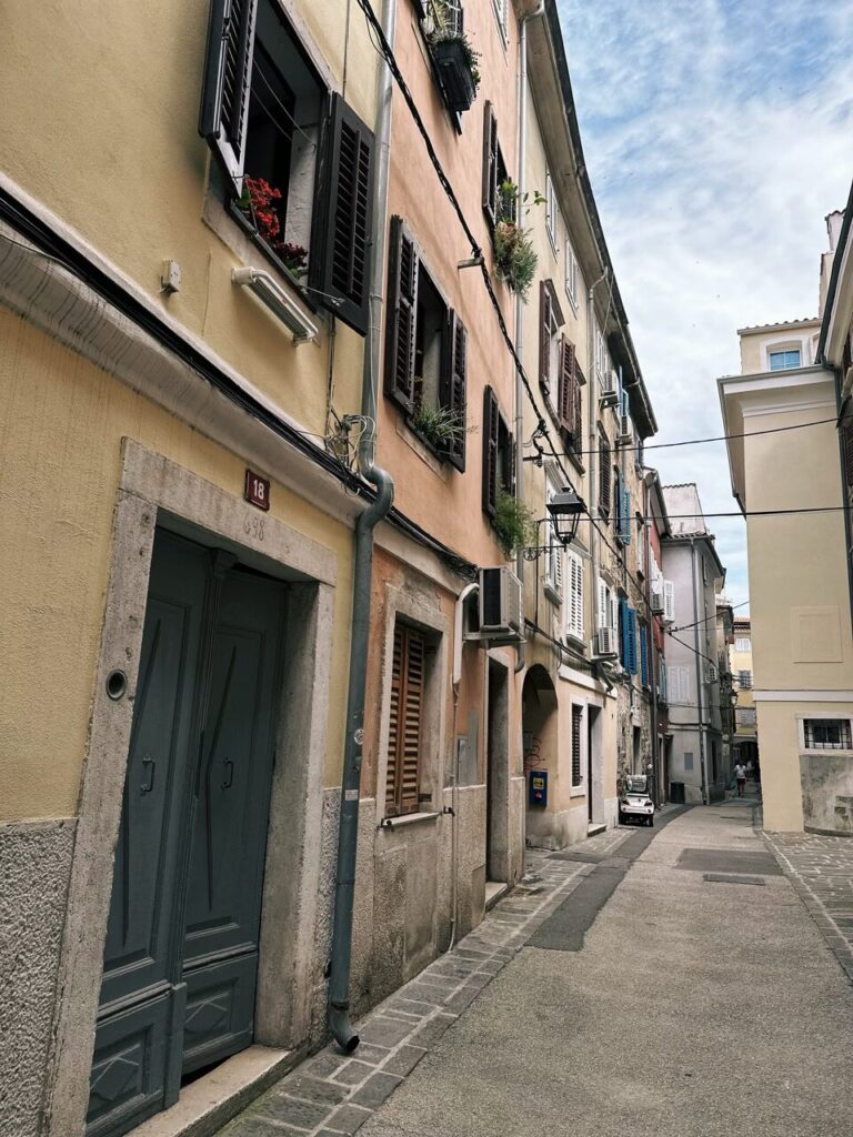 Narrow street with colorful historic buildings in Piran, Slovenia