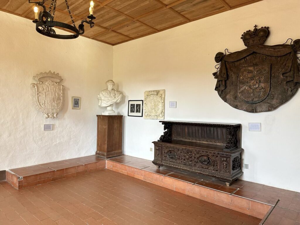 Ornate crests and a bust decorate a room inside Predjama Castle