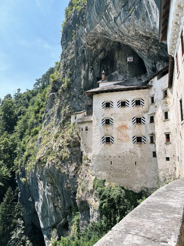 Predjama Castle built into the side of a massive limestone cliff face