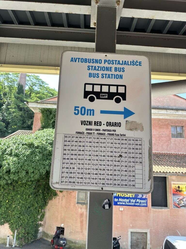 Bus station sign with a detailed schedule for Piran in Slovenia