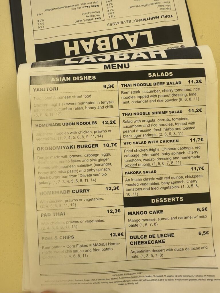 Printed menu for Lajbah restaurant featuring Asian dishes, salads, and desserts